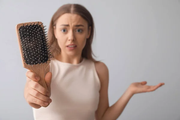 Stressed Young Woman Hair Loss Problem Holding Brush Light Background — Stock Photo, Image