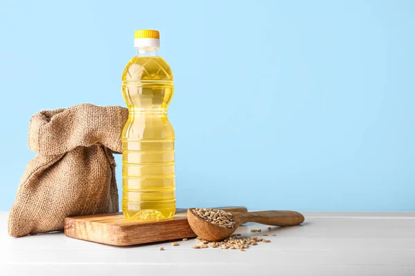 Bottle Oil Bag Board Spoon Sunflower Seeds Table Blue Background — Stock Photo, Image
