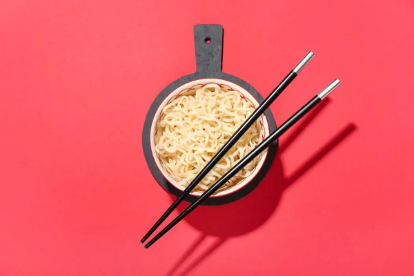 Bowl Tasty Noodles Chopsticks Red Background — Stock Photo, Image