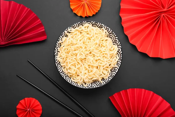 配上碗中美味的面条和黑色背景的筷子 — 图库照片