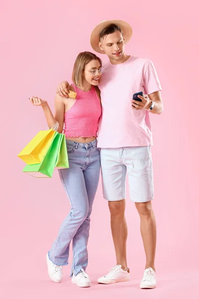Young Couple Credit Card Mobile Phone Shopping Bags Pink Background — Stock Photo, Image