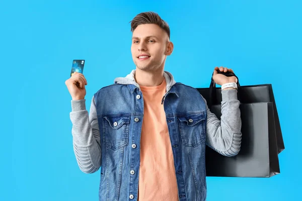 Young Man Shopping Bags Credit Card Blue Background — Stock Photo, Image