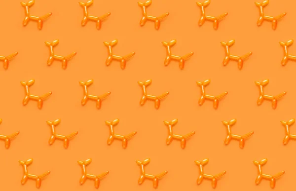 Many dogs made of balloons on orange background. Pattern for design