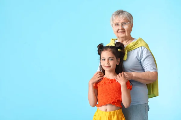 Senior Woman Her Little Granddaughter Blue Background — Stock Photo, Image