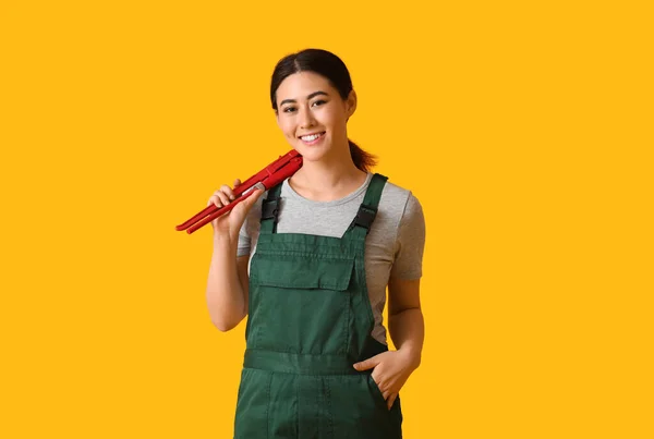Asian Female Plumber Pipe Wrench Yellow Background — Stock Photo, Image