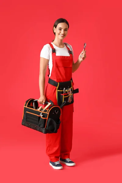 Female Plumber Holding Bag Tools Red Background — Stock Photo, Image