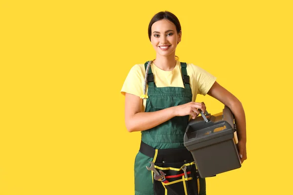 Female Plumber Holding Bag Tools Yellow Background — Stock Photo, Image