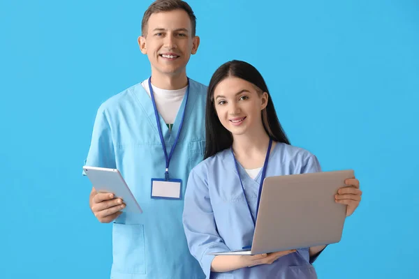 Medizinische Assistenten Mit Laptop Und Tablet Computer Auf Blauem Hintergrund — Stockfoto
