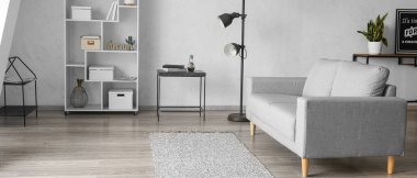 Rahat kanepesi ve raf ünitesi olan aydınlık oturma odasının içinde.