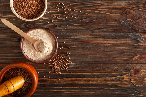 Bowls Flour Buckwheat Grains Spoon Dark Wooden Background — Stock Photo, Image