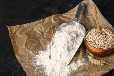 Unlu kepçe ve koyu renkli buğdaylı kase.