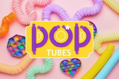 Farklı renklerde pop tüpleri ve pop Pembe arka planda kıpırdanmalar