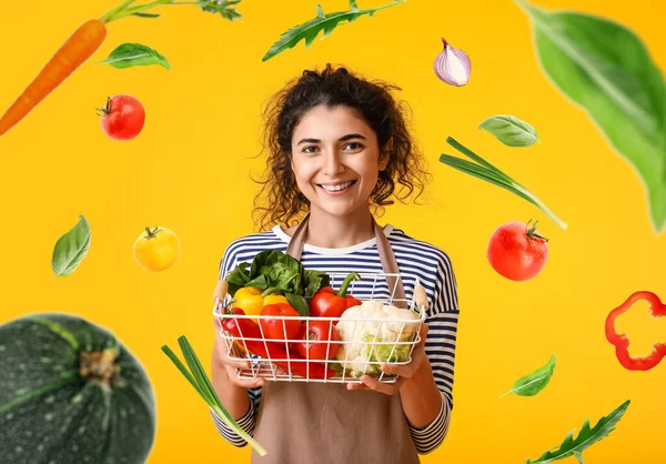 Young Housewife Basket Flying Fresh Vegetables Yellow Background — Stock Photo, Image