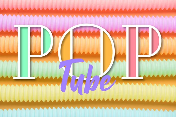 Turuncu arka planda farklı renkli pop tüpleri