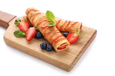 Beyaz arka planda ince krepler, çilekler ve yabanmersinli pano