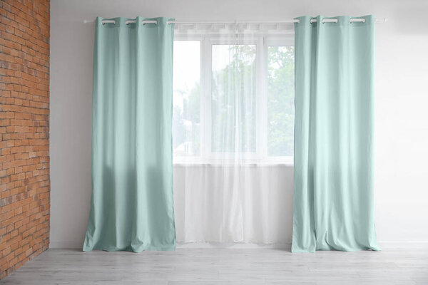 Beautiful curtains in cozy empty room