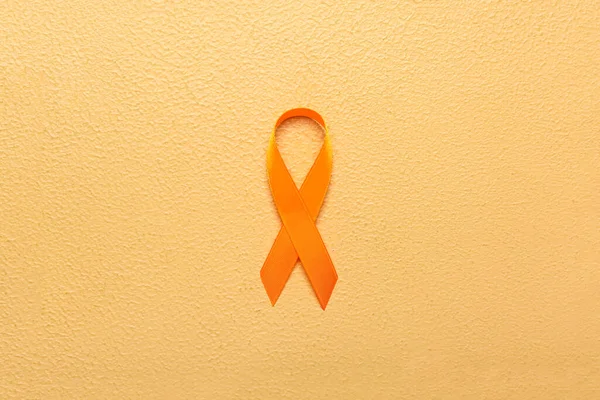 Orange Awareness Ribbon Beige Background Kidney Cancer Concept — Stock Photo, Image
