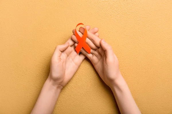 Woman Orange Awareness Ribbon Beige Background Kidney Cancer Concept — Stock Photo, Image