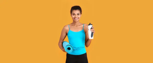 Sporty African American Woman Bottle Water Yoga Mat Orange Background Stock Picture