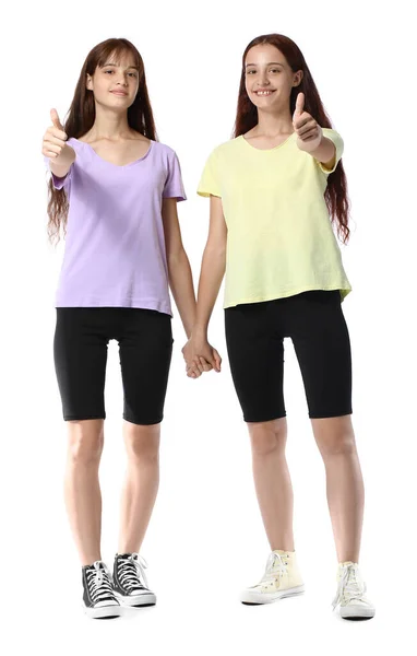 Teenage Twin Sisters Showing Thumbs White Background — Stock Photo, Image