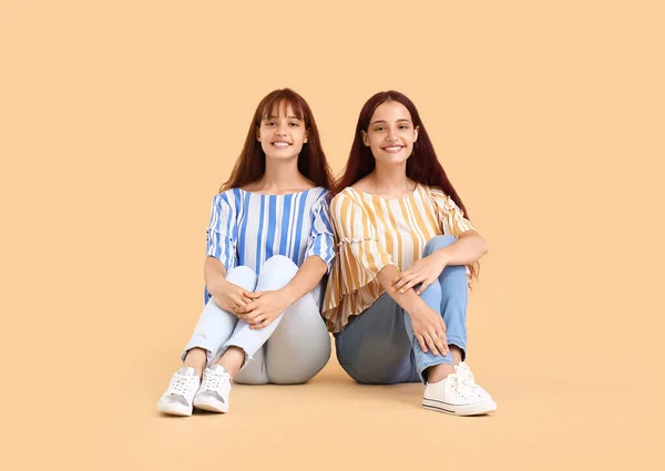 Teenage Twin Sisters Sitting Beige Background — Stock Photo, Image