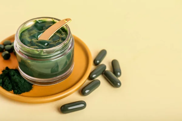 Plate Jar Spirulina Facial Mask Powder Pills Color Background — Stockfoto