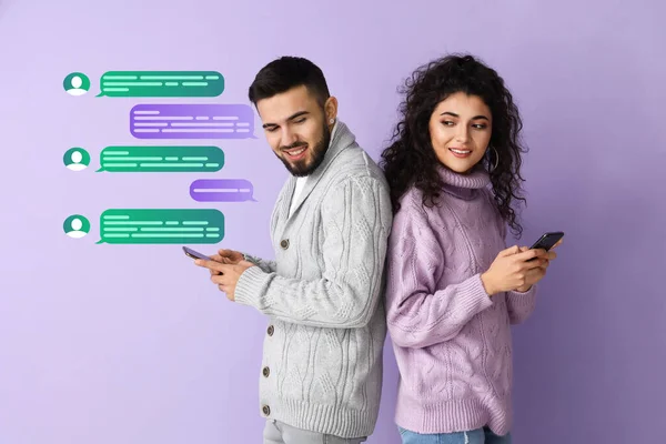 Happy Young Couple Mobile Phones Chatting Online Lilac Background — Stock Photo, Image