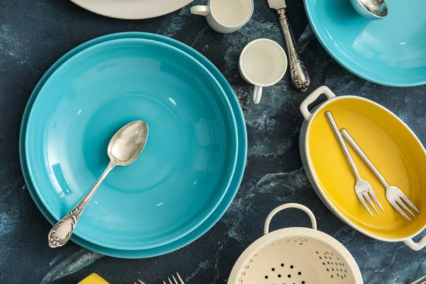Colorful Dinnerware Kitchen Utensils Blue Background Closeup — Stock Photo, Image