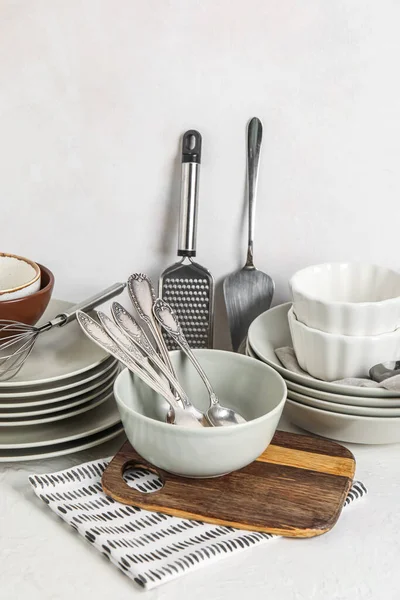 Set of clean dinnerware on light background