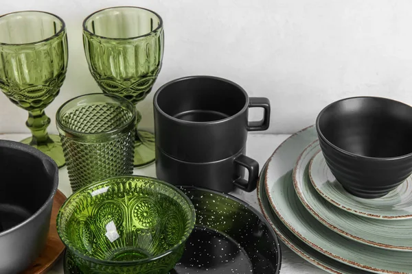Set of stylish dark dinnerware on light background, closeup