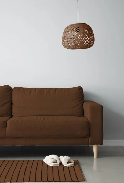 Modern interior of living room with cozy brown sofa