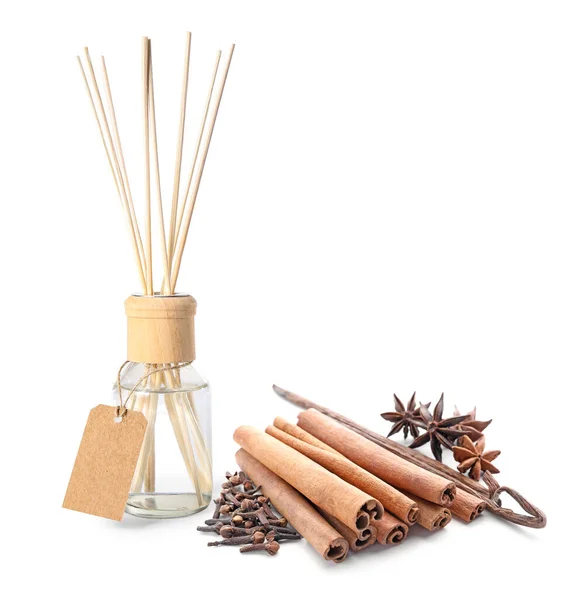 Reed diffuser and spices on white background