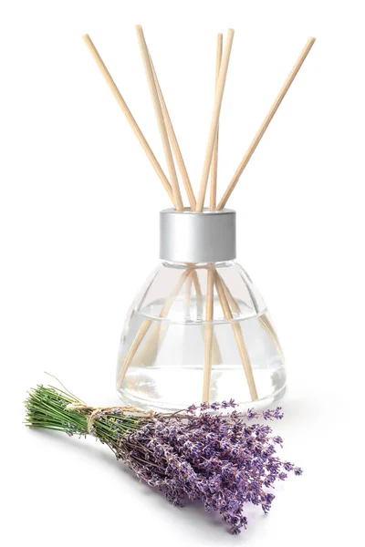 Reed diffuser and lavender on white background