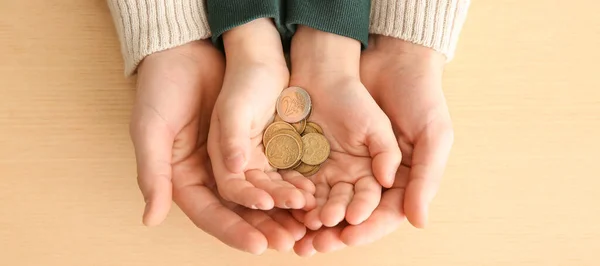 Hands Man His Son Holding Coins Wooden Background Concept Alimony — Stockfoto