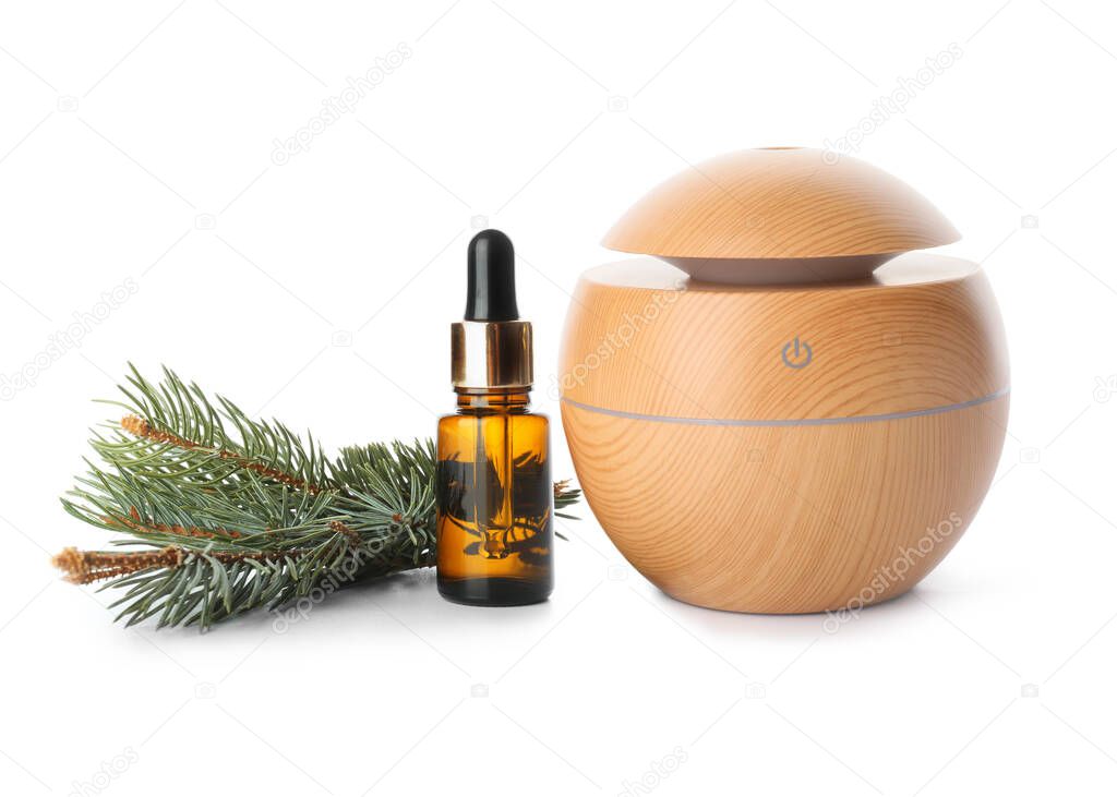 Aroma oil diffuser and coniferous essential oil on white background