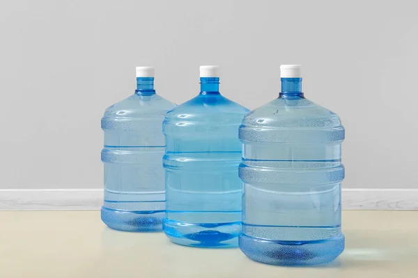 Bottles of clean water on floor near light wall