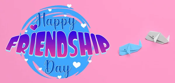 Paper whales and text HAPPY FRIENDSHIP DAY on pink background