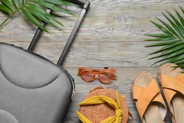 Female Accessories Travelling Suitcase Palm Leaves Grey Wooden Background — Stock Photo, Image