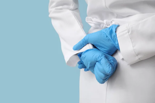 Doctor Holding Hands Rubber Gloves Back Blue Background Closeup — Stock Photo, Image