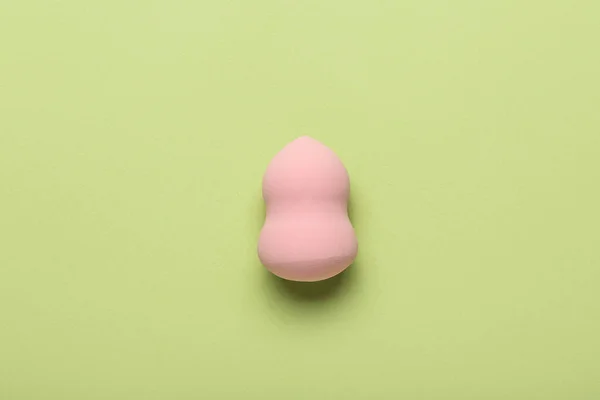 Makeup sponge on green background