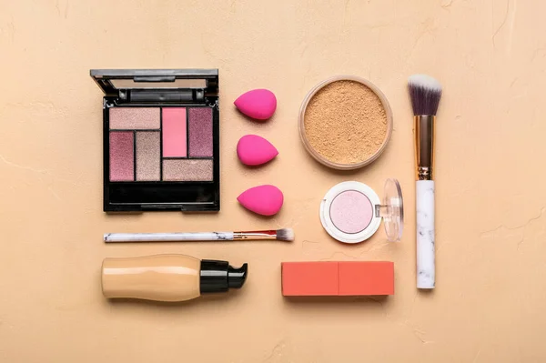 Set of cosmetics and makeup accessories on color background