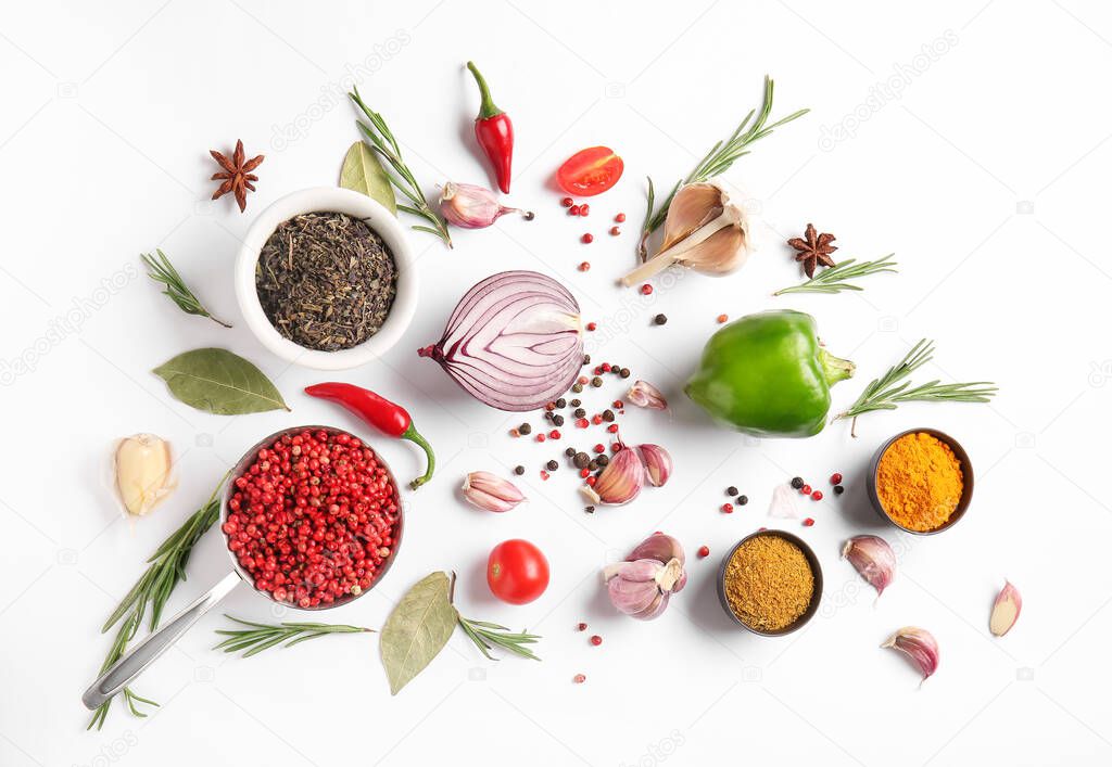 Composition with different spices, herbs and vegetables on white background