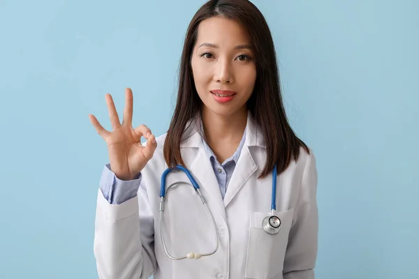 Female Asian Doctor Showing Blue Background — 스톡 사진