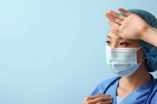Tired Asian Nurse Medical Mask Blue Background — Stockfoto