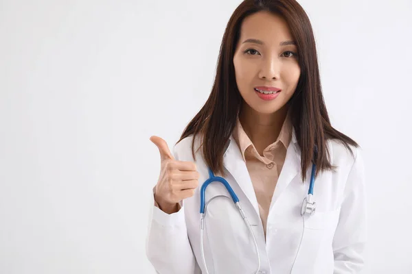 Female Asian Doctor Showing Thumb White Background —  Fotos de Stock