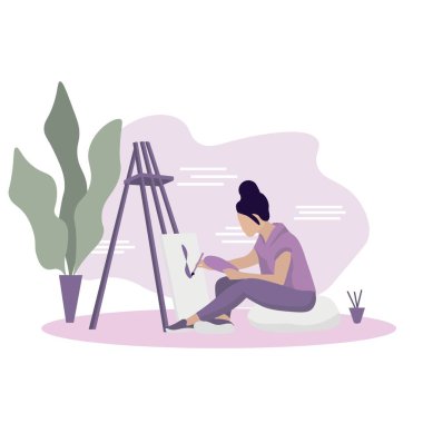 Young female artist painting picture at home