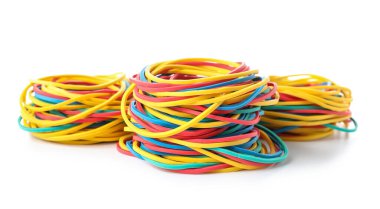 Three stacks of colorful rubber bands isolated on white background