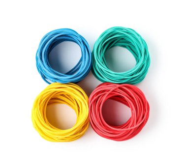 Stacks of elastic rubber bands on white background