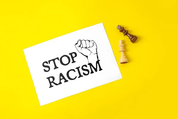 Chess Pieces Paper Sheet Text Stop Racism Color Background — Fotografia de Stock