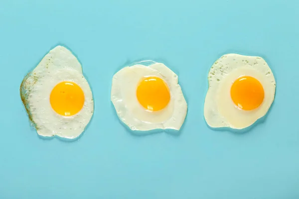 Tasty Fried Eggs Blue Background — Foto de Stock